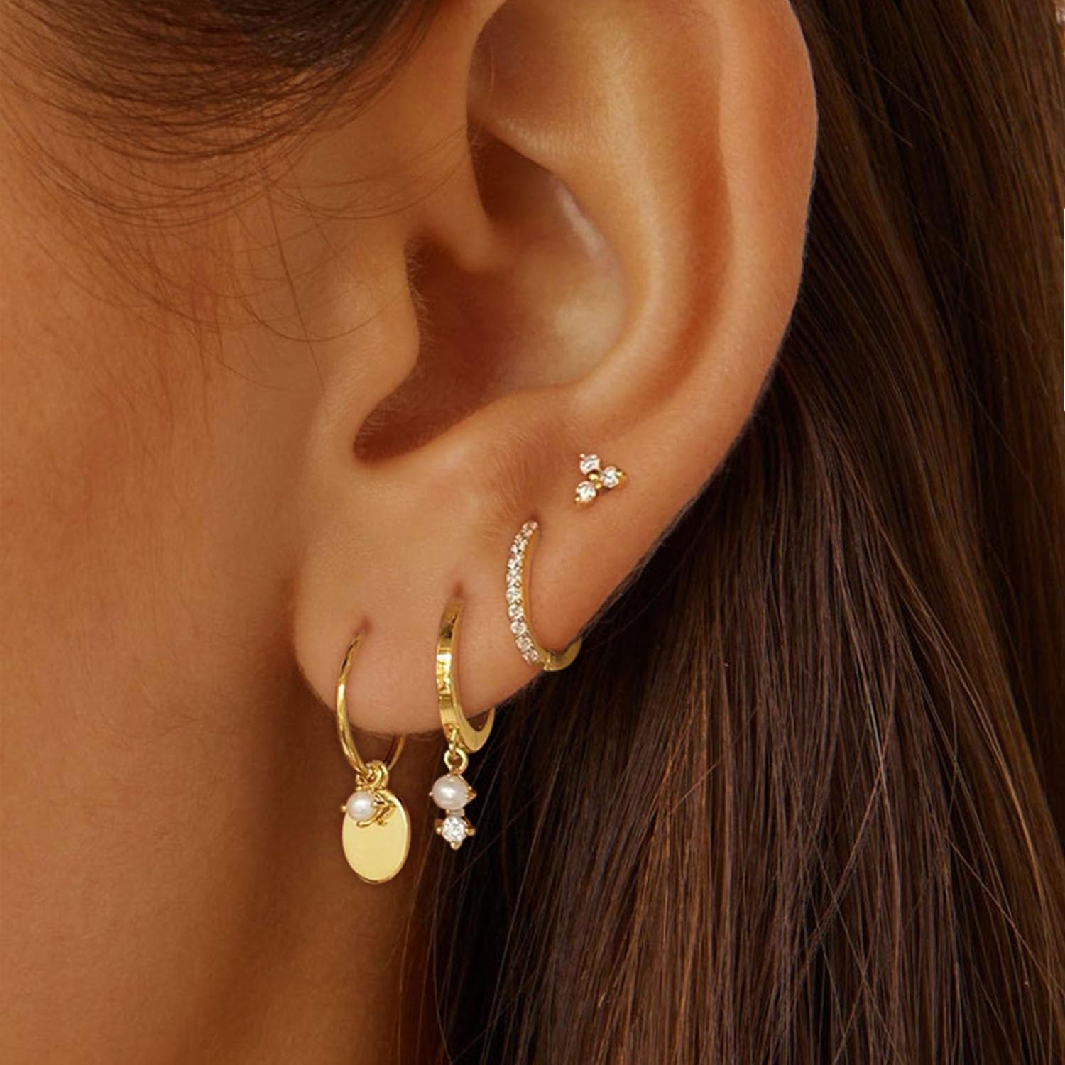Gold earring set for women including huggie hoops, pearl dangle and stackable minimalist earrings, trendy jewelry flat lay