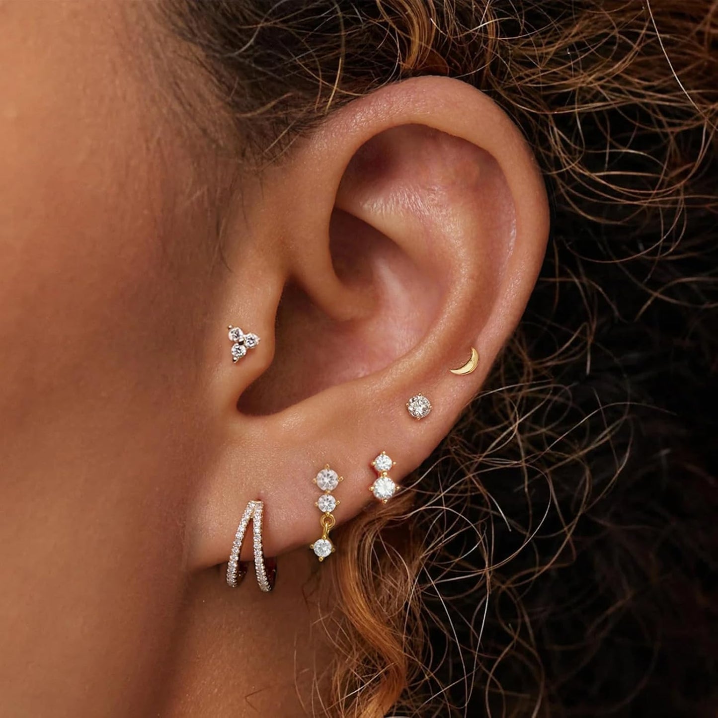 Gold stud earrings for multiple piercings, cartilage and lobe earrings worn by model, dainty minimalist jewelry set